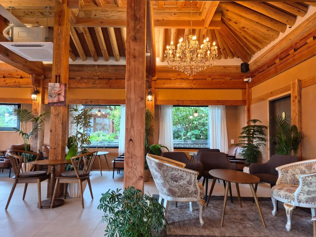 Interior of Cafe Dahwa with wooden hanok beams and modern cafe furnishings