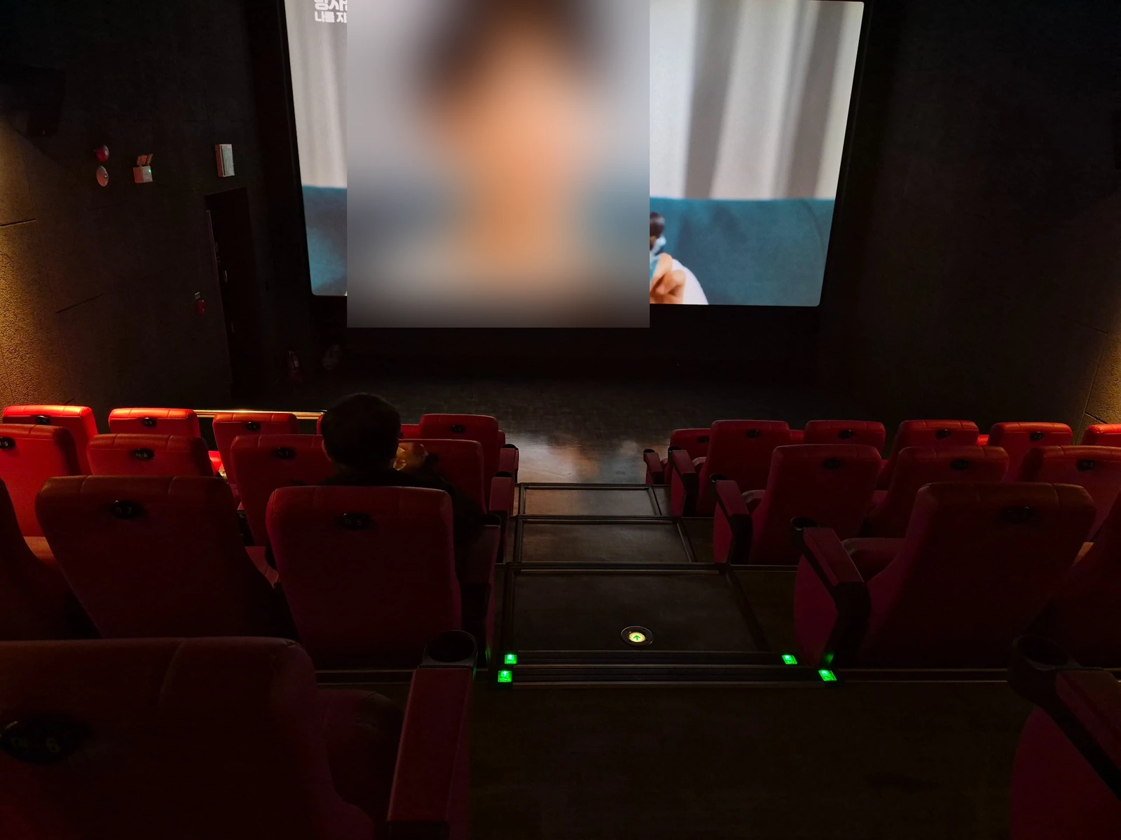 Inside a small movie theater during a late-night movie date in rural South Korea