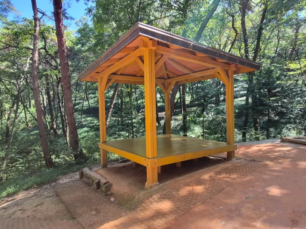 Rest area surrounded by forest along the Mulmusan barefoot red clay trail