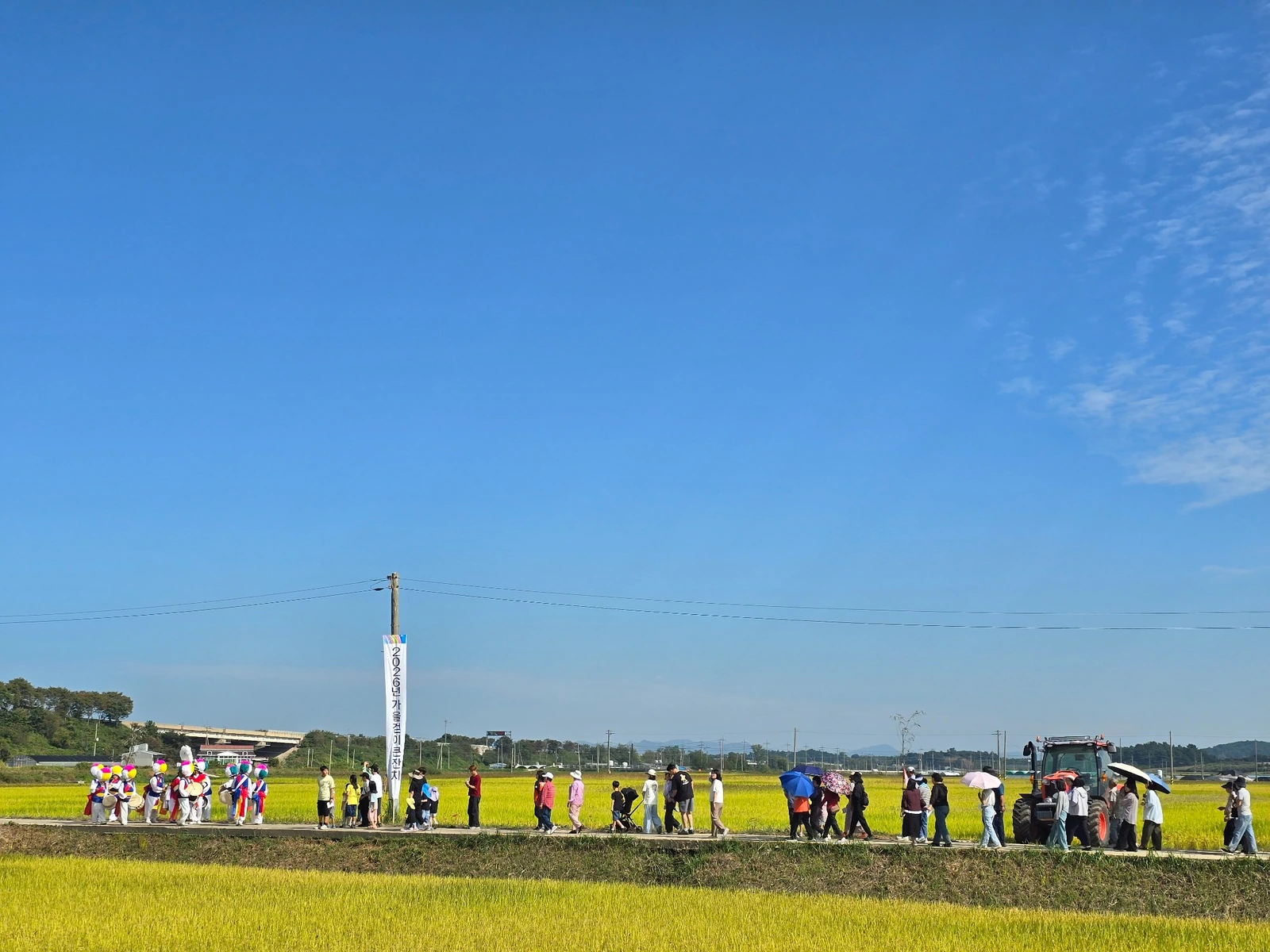 A rural autumn harvest festival surrounded by golden rice fields in Myoryang, South Korea