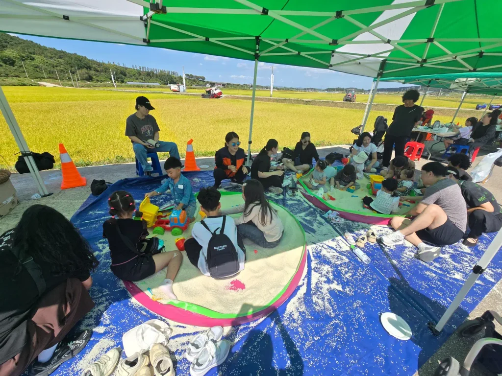 Children playing with rice at a harvest festival in rural Korea