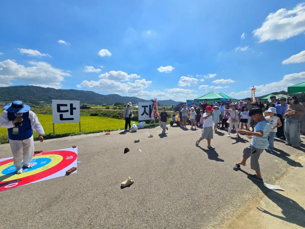 Children and local residents taking part in a game at a rural Korean harvest festival