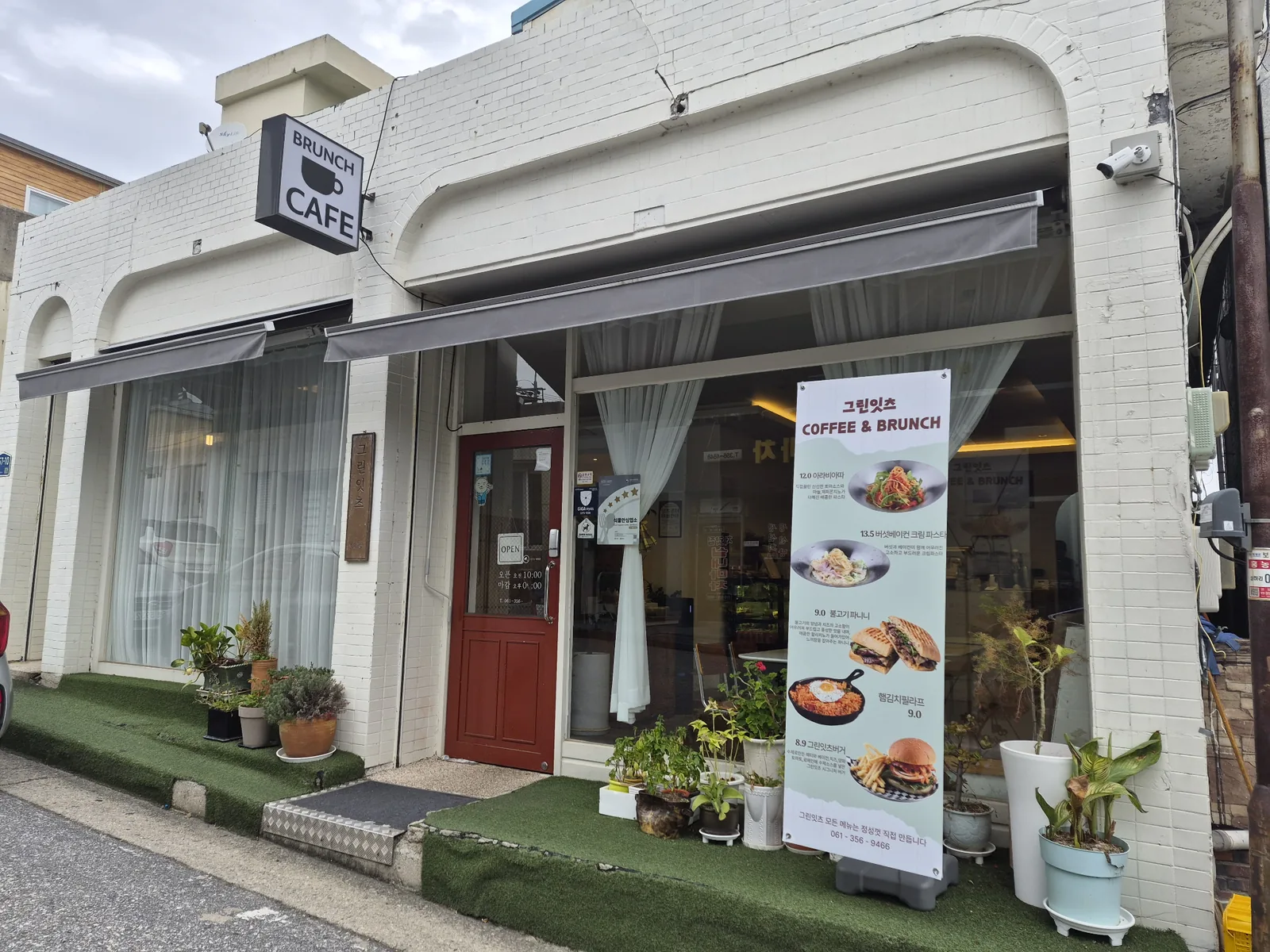 White brick exterior and red entrance of Green Eats brunch cafe in Hongnong-eup, Yeonggwang, South Korea.
