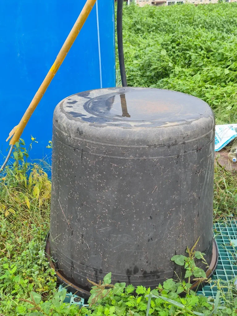 Large black multipurpose container used around a farming area in rural Korea