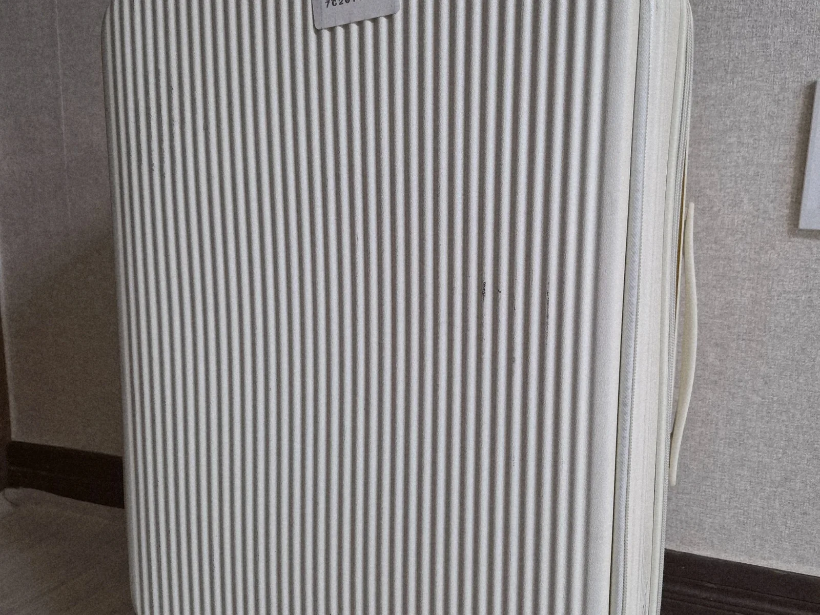White travel suitcase packed for a rural Korean elementary school student's cultural trip to Osaka, Japan